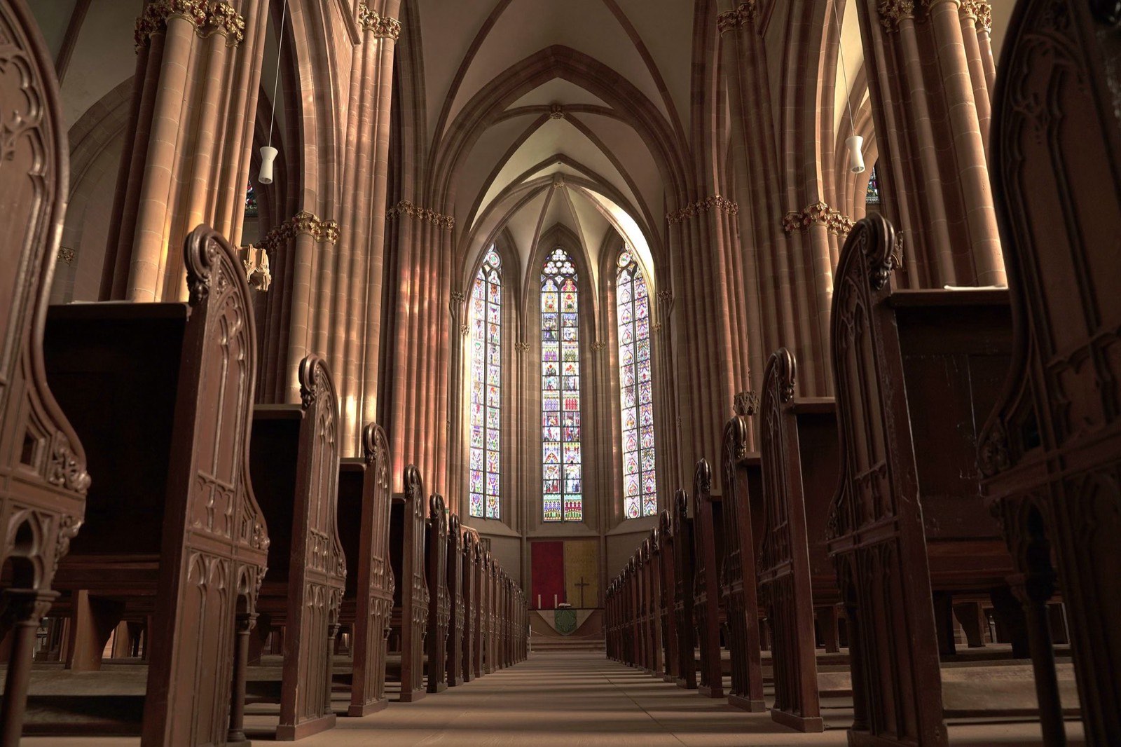 The interior of a church sanctuary with stained glass